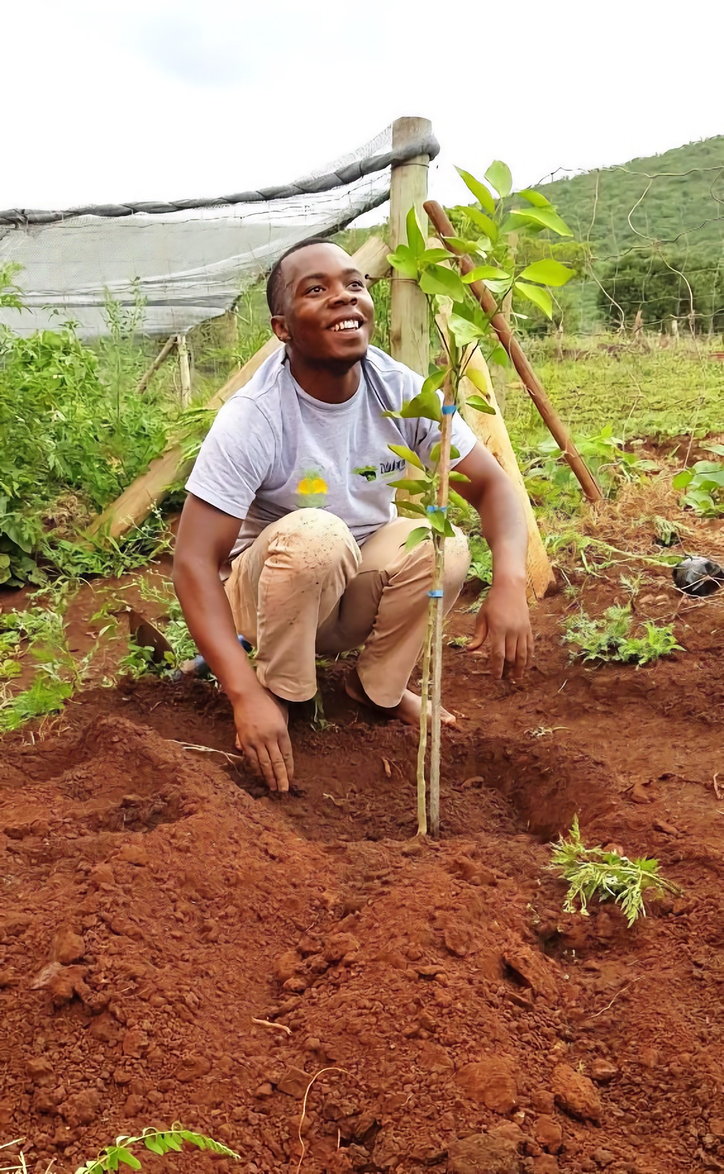 Zimisele Luthuli beside a newly planted lemon tree at Ubhejane Crèche