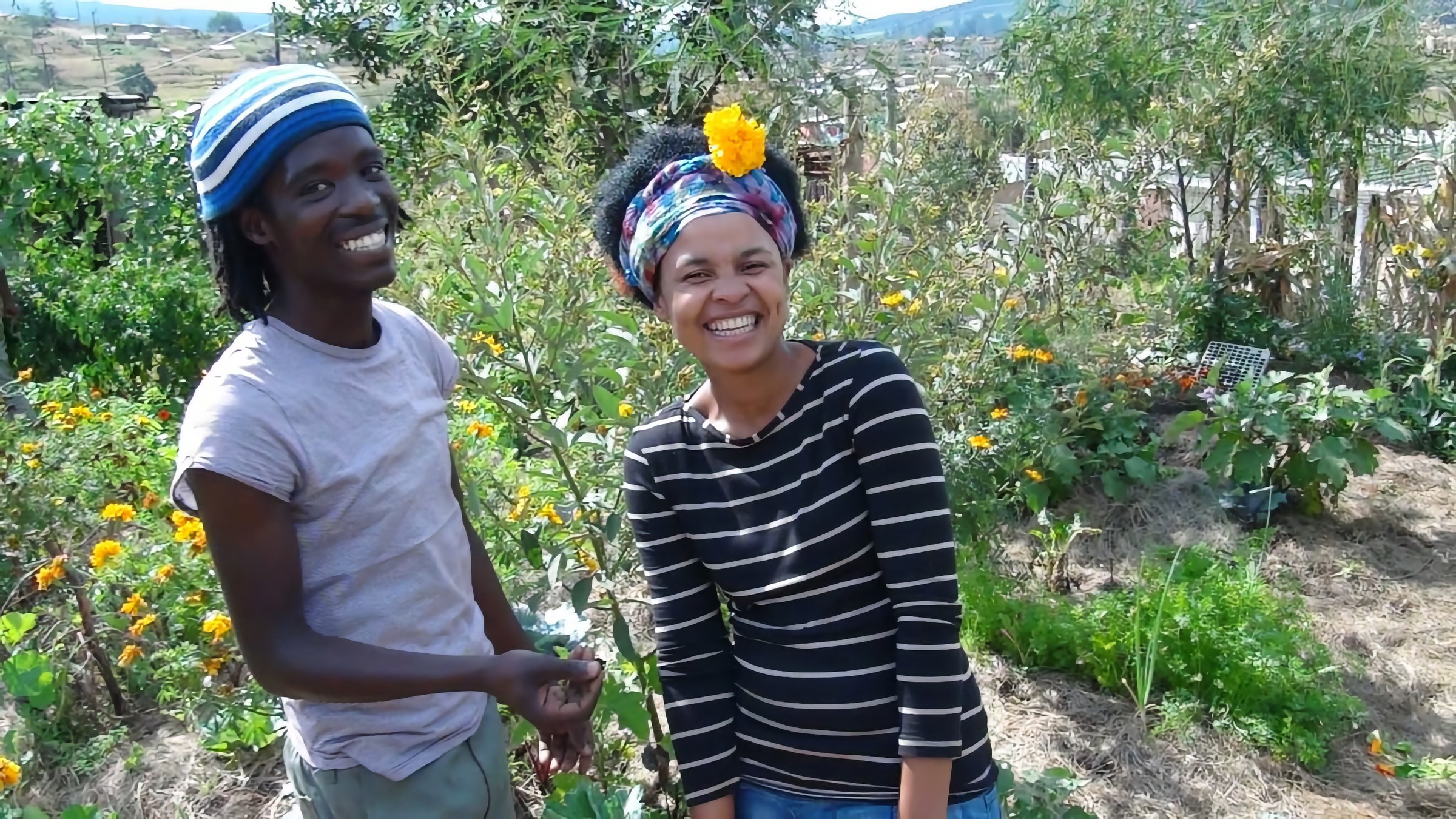 Two people smiling in the established Richmond Homestead Abundance Garden, KwaZulu-Natal
