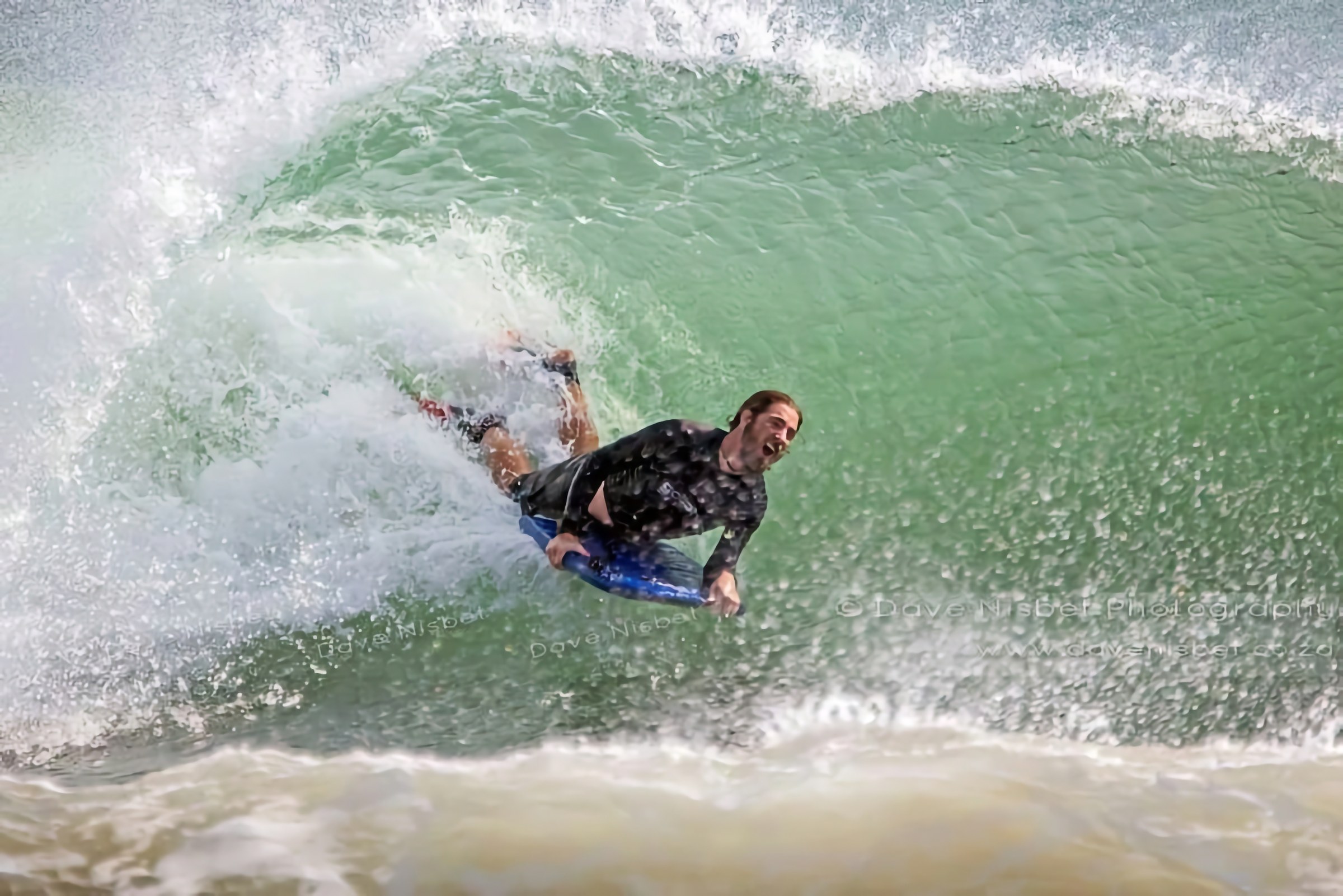 Rory Clark surfing through the barrel of a breaking wave