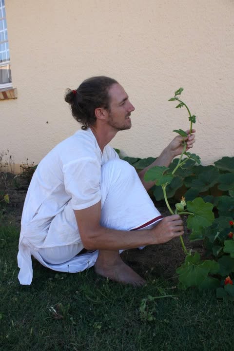 Rory holding a pumpkin vine in the vegetable garden at the Hare Krishna Centre in Port Elizabeth